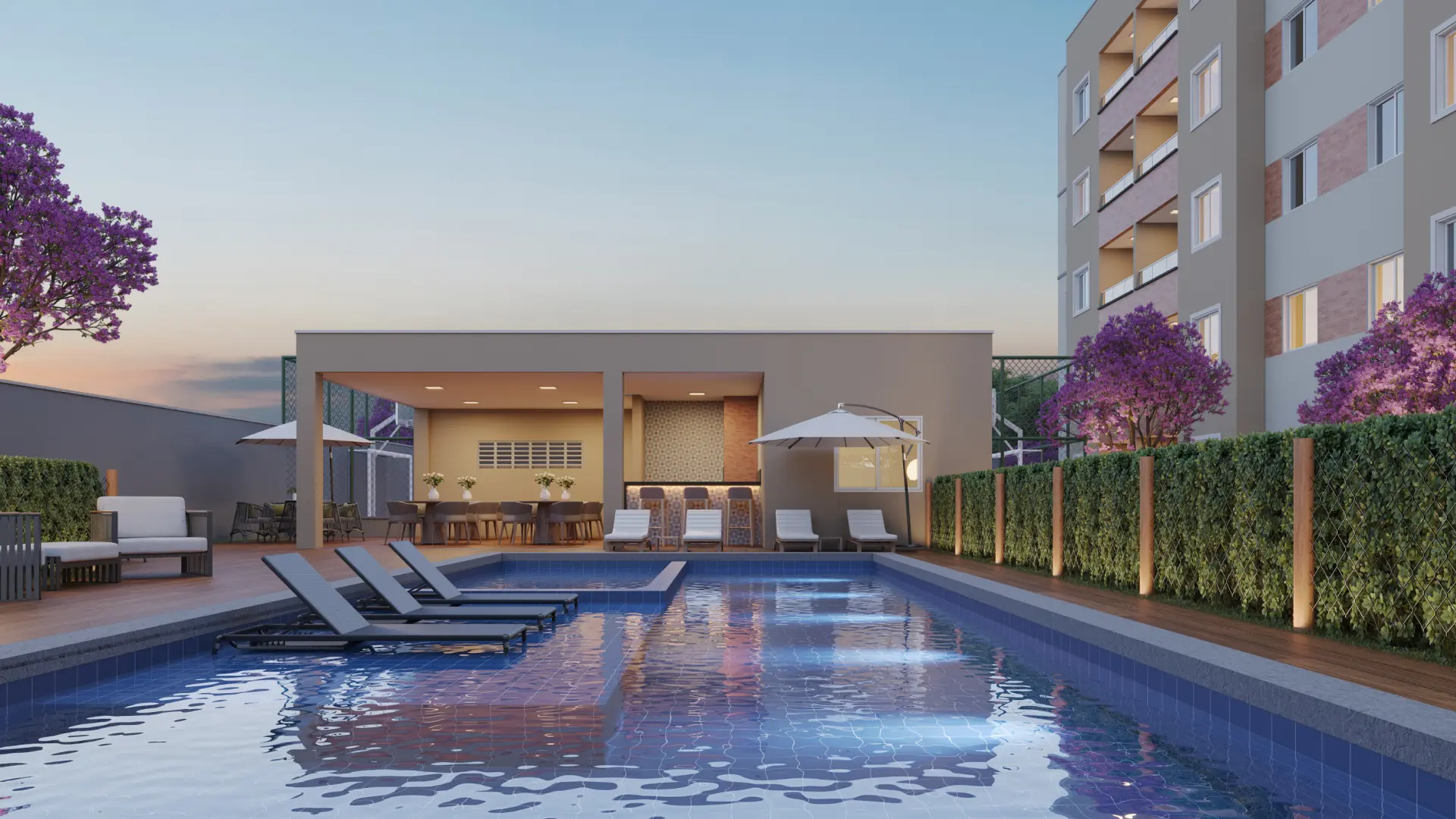 Piscina do Alameda dos Ipês ao entardecer, com espaço gourmet ao fundo